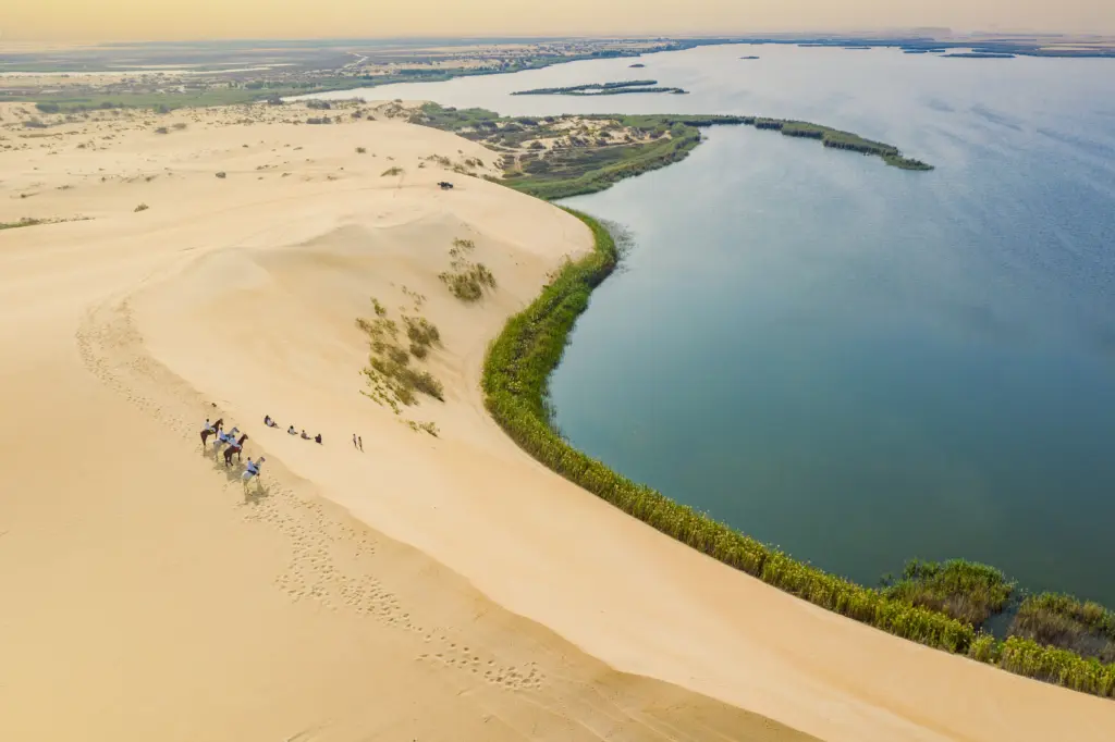 A wide angle aerial shot of the aqua waters of Asfar Lake, ringe