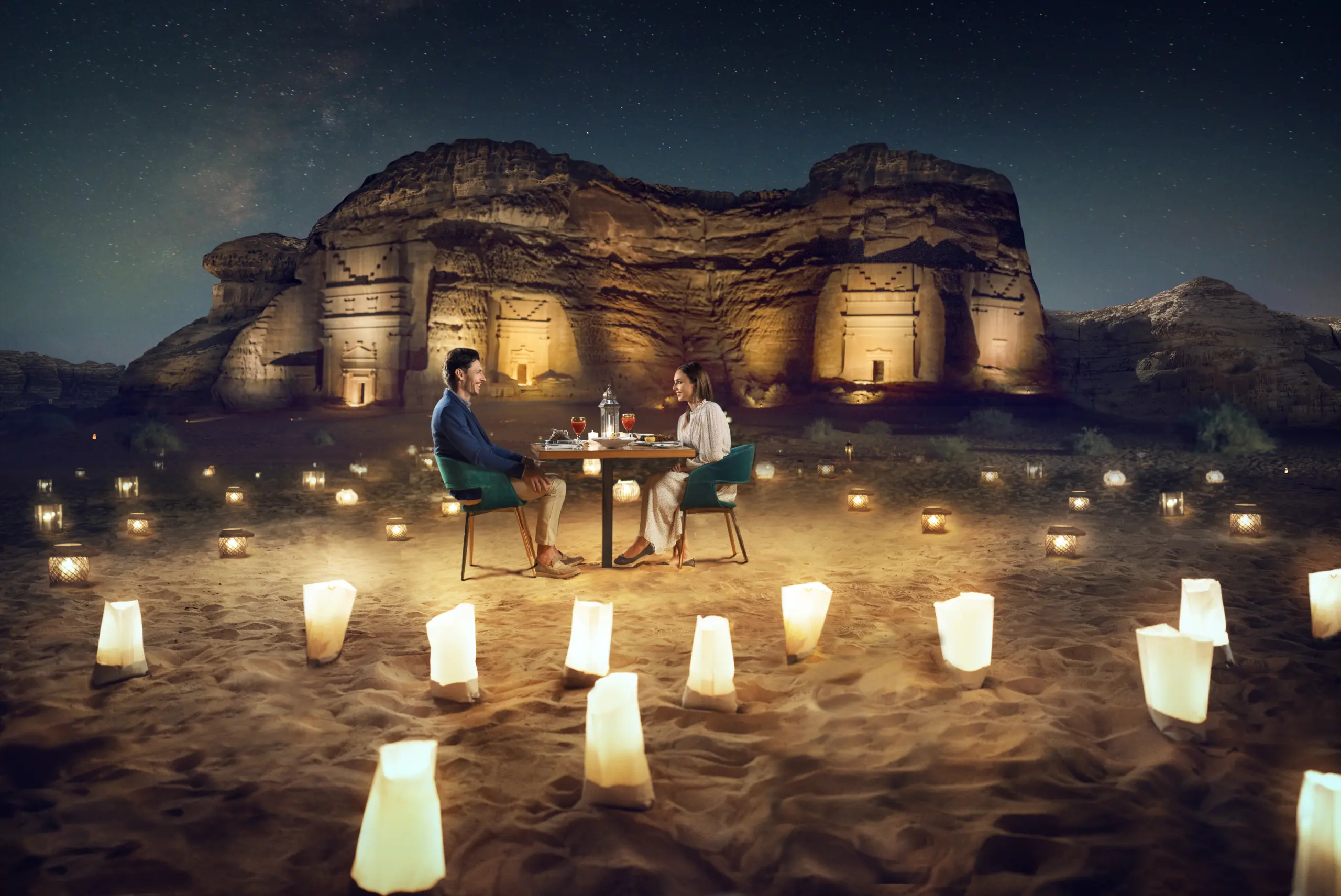A young couple having a romantic dinner under the stars, with th