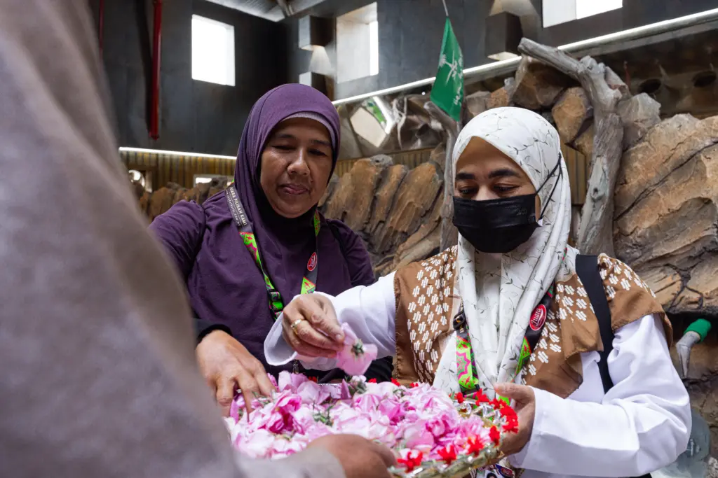 Two women looking at roses in a basket